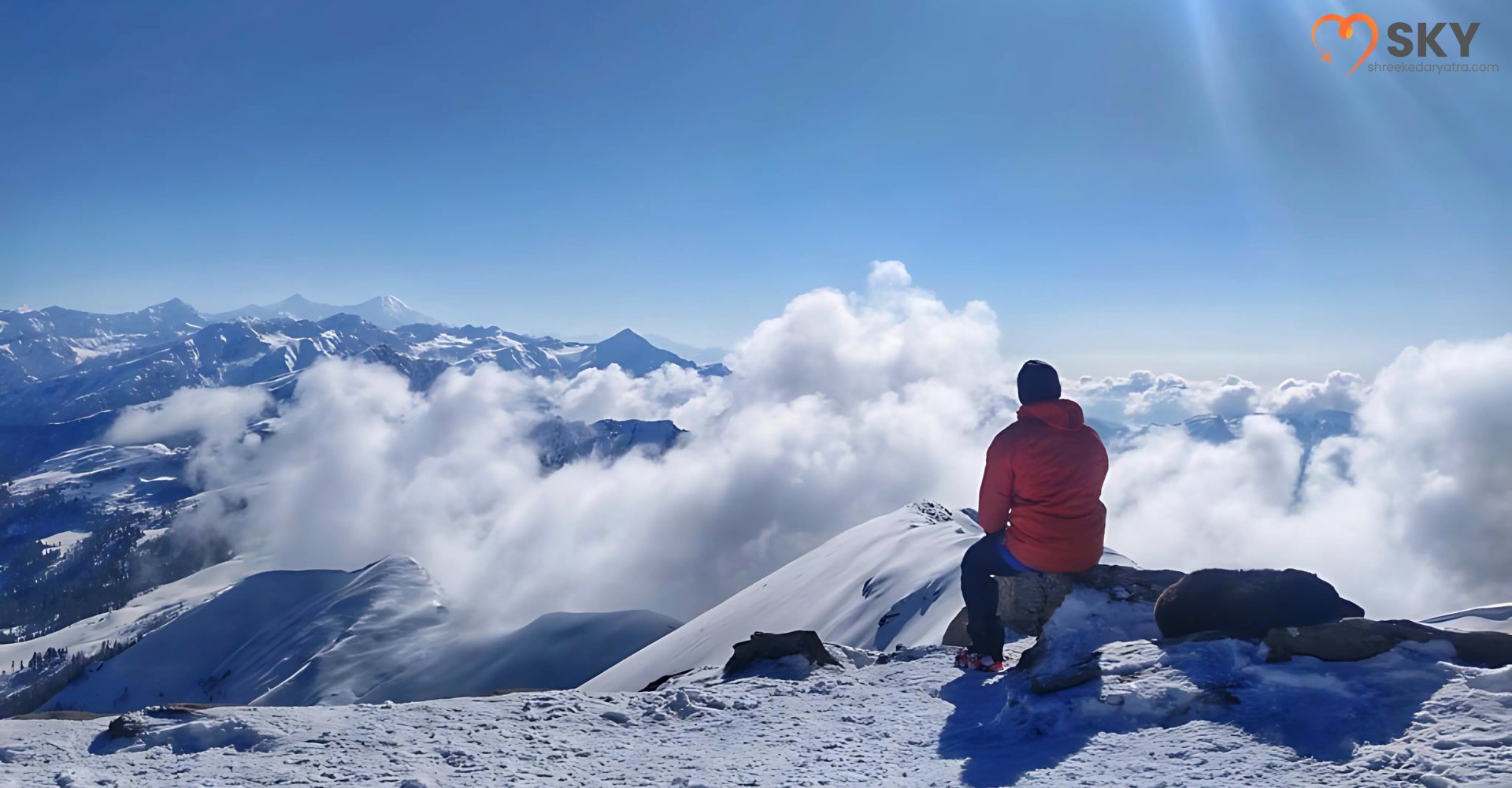 Clear blue skies and snow-covered peaks showing the best time for Kedarkantha Trek in the Himalayas
