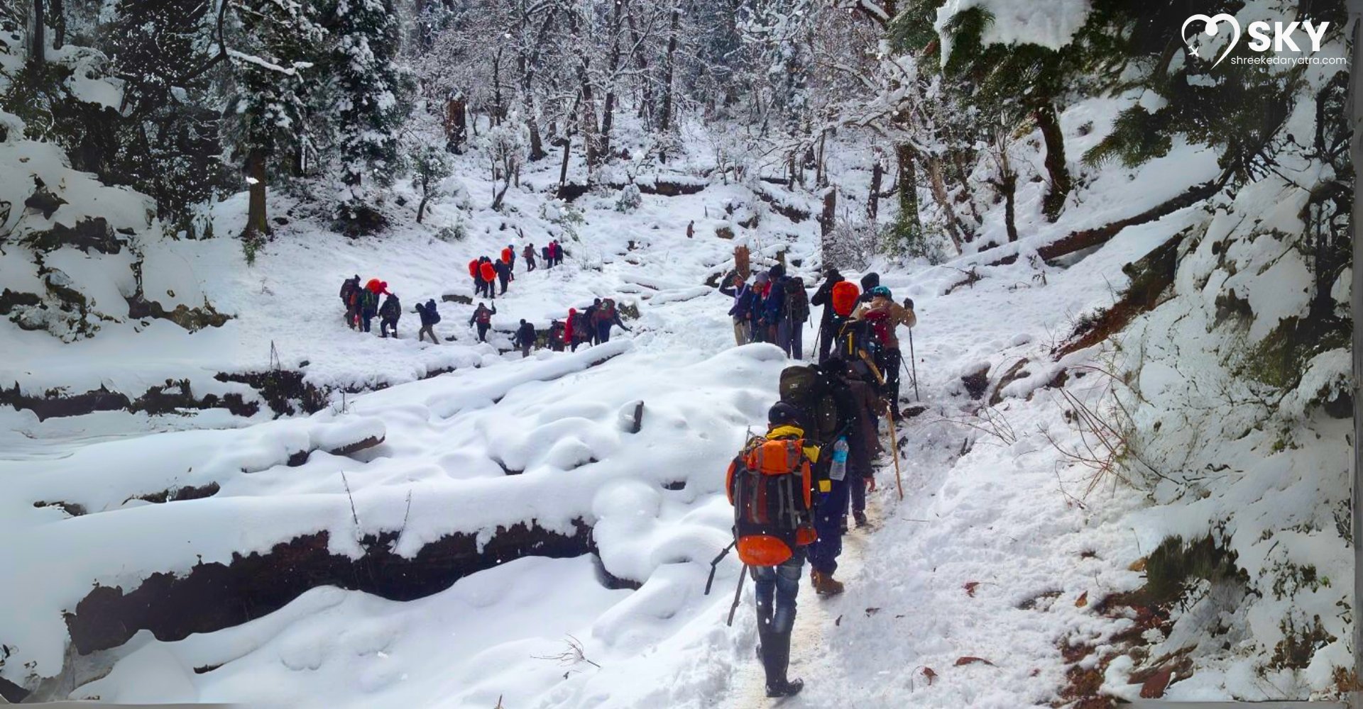 Trekkers enjoying Kedarkantha Snow Trek in Uttarakhand with breathtaking Himalayan views