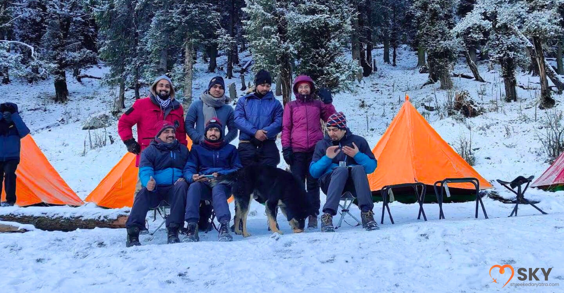 Group of trekkers reviewing maps and gear as part of a planned Kedarkantha Trek package